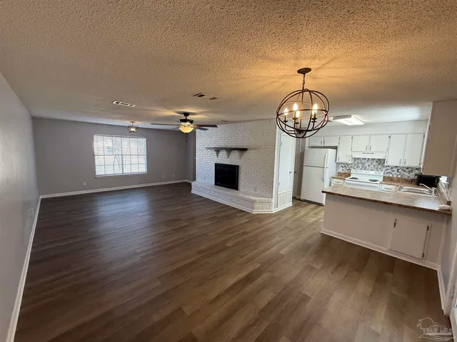 a open kitchen with sink and cabinets