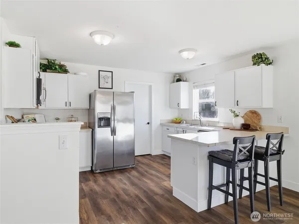 a kitchen with kitchen island a sink stove and refrigerator