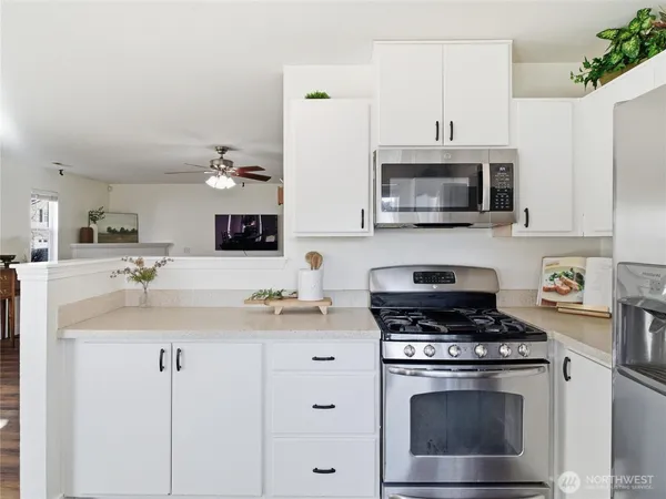 a kitchen with cabinets stainless steel appliances a sink and a stove