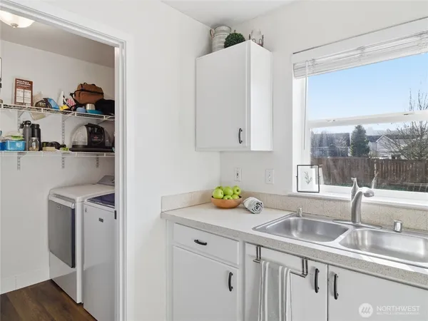 a kitchen with granite countertop a sink a stove and cabinets
