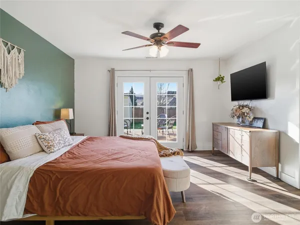 a bedroom with a large bed and a flat screen tv