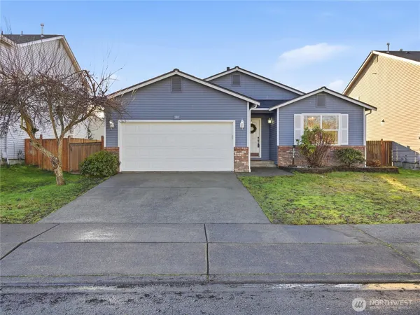 a front view of a house with a yard and garage