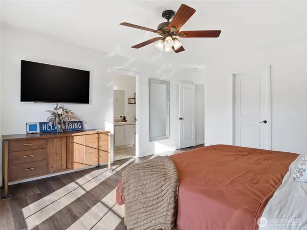 a bedroom with a bed and a flat screen tv