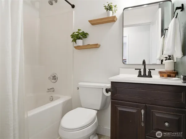 a bathroom with a sink a toilet and bathtub