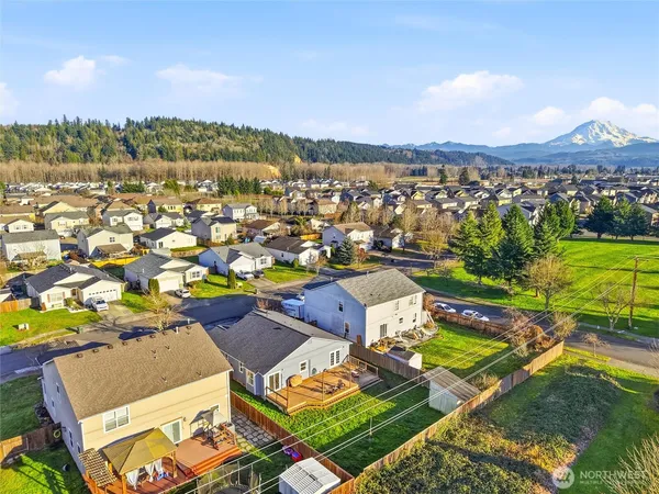 an aerial view of residential houses with outdoor space and city view