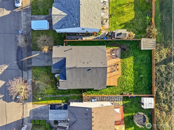 an aerial view of a house with a garden and lake view