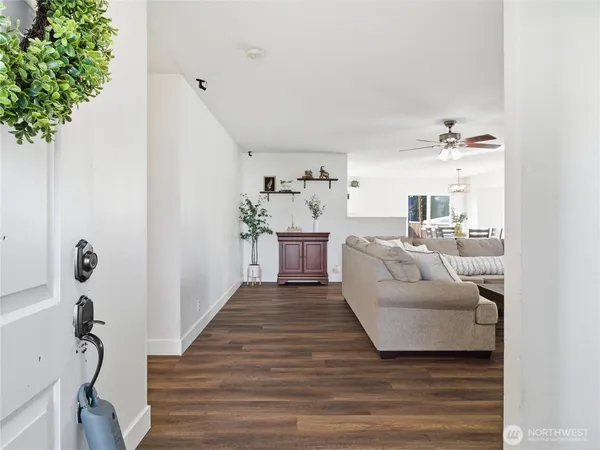 a living room with furniture and a potted plant