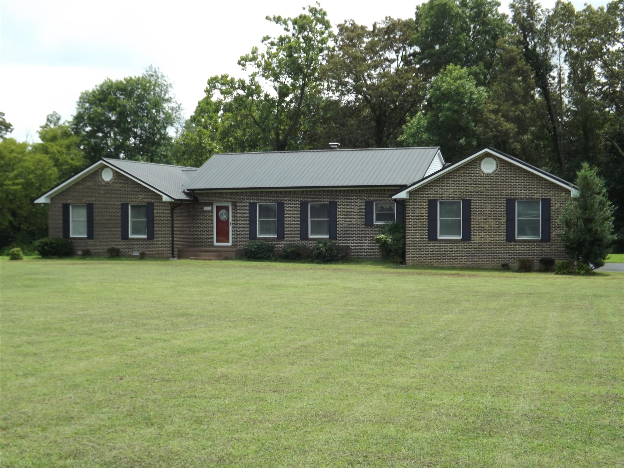 1600 Mud Creek Road Morrison, TN 37357 - Photo 1 of 28 a front view of a house with a garden