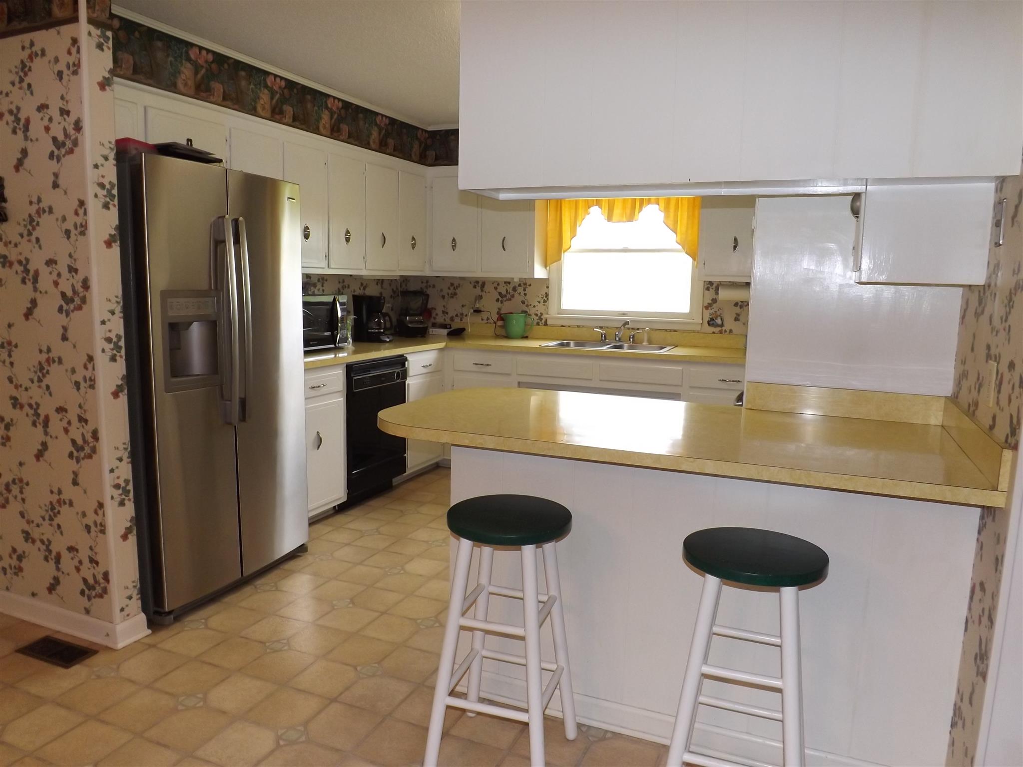 1600 Mud Creek Road Morrison, TN 37357 - Photo 14 of 28 a kitchen with stainless steel appliances granite countertop a sink and a refrigerator
