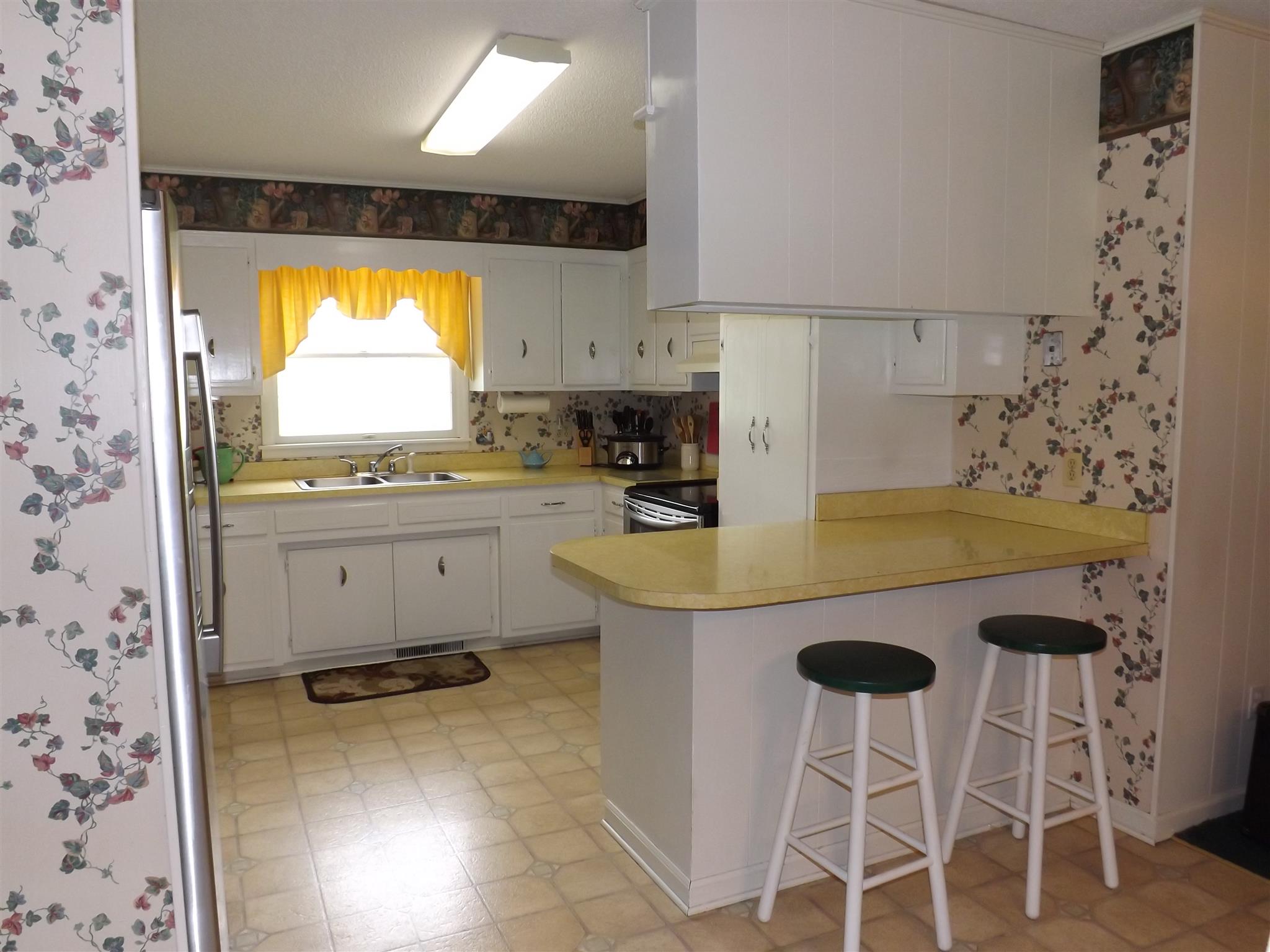 1600 Mud Creek Road Morrison, TN 37357 - Photo 16 of 28 a kitchen with a sink a stove a table and chairs