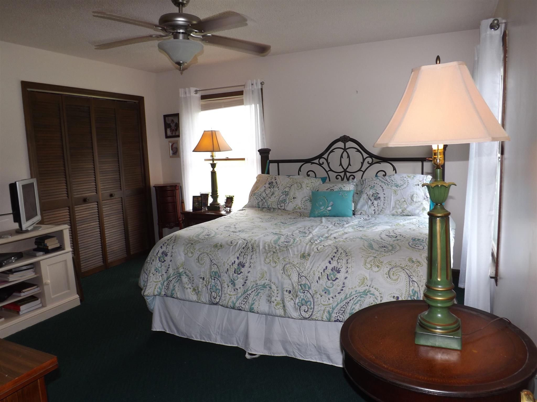 1600 Mud Creek Road Morrison, TN 37357 - Photo 19 of 28 a bedroom with a bed and a chandelier