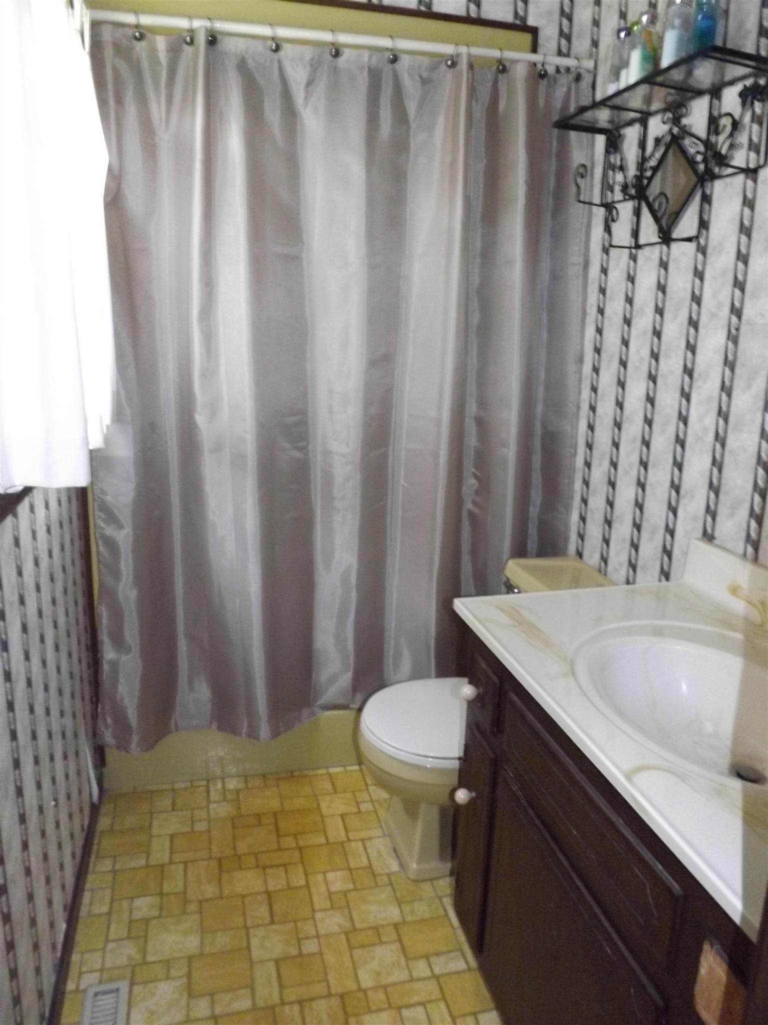 1600 Mud Creek Road Morrison, TN 37357 - Photo 21 of 28 a bathroom with a granite countertop sink and a toilet