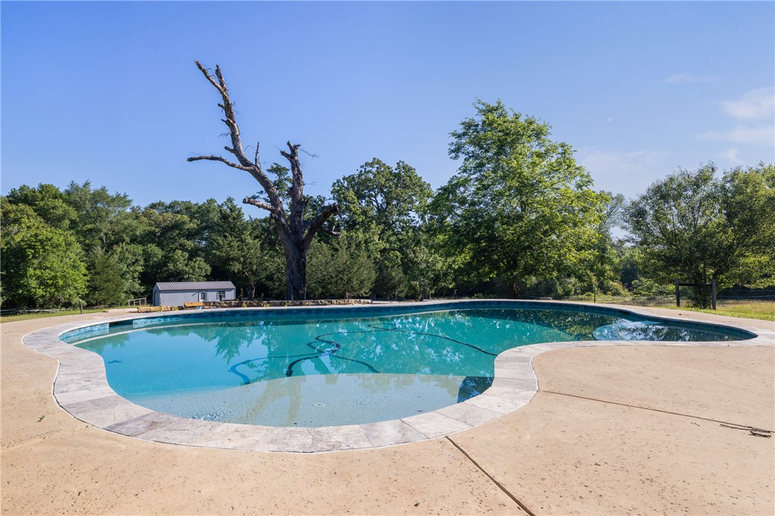 871 Cazey Loop Franklin, TX 77856 - Photo 32 of 42 a view of a swimming pool with a yard