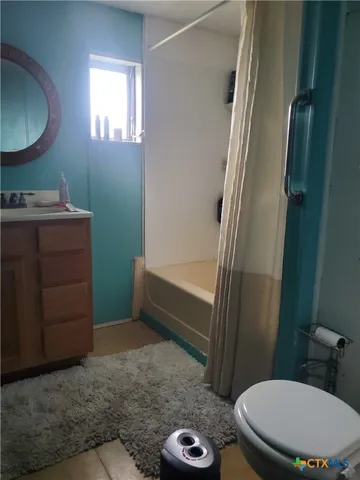 a bathroom with a toilet a sink and a mirror