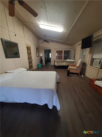 a bedroom with furniture and a wooden floor