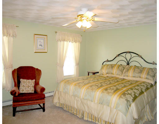 140 Cleveland Street Woonsocket, RI 02895 - Photo 14 of 26 a bedroom with a bed and a painting on the wall