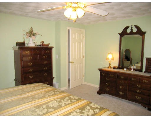140 Cleveland Street Woonsocket, RI 02895 - Photo 15 of 26 a bedroom with a bed and a mirror