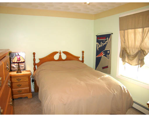 140 Cleveland Street Woonsocket, RI 02895 - Photo 19 of 26 a bedroom with a bed and a painting on the wall