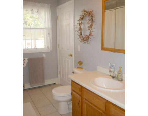 140 Cleveland Street Woonsocket, RI 02895 - Photo 20 of 26 a bathroom with a granite countertop sink a toilet and shower