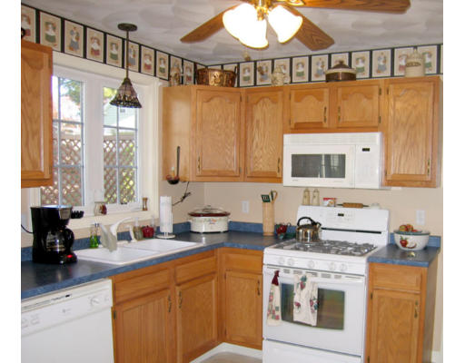 140 Cleveland Street Woonsocket, RI 02895 - Photo 3 of 26 a kitchen with stainless steel appliances granite countertop a sink a stove and a microwave