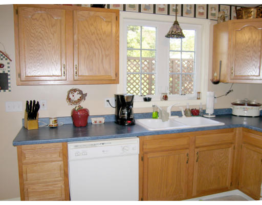 140 Cleveland Street Woonsocket, RI 02895 - Photo 4 of 26 a kitchen with sink cabinets and window