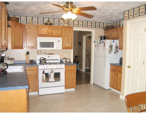 140 Cleveland Street Woonsocket, RI 02895 - Photo 5 of 26 a kitchen with a stove a refrigerator and a sink