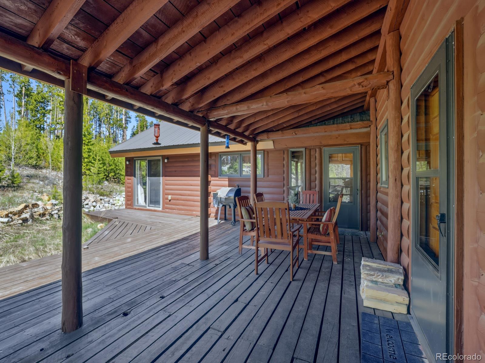 341 Anderson Road Walden, CO 80480 - Photo 38 of 50 a view of a patio with table and chairs and wooden floor