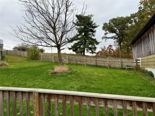 a view of a house with a yard and sitting area