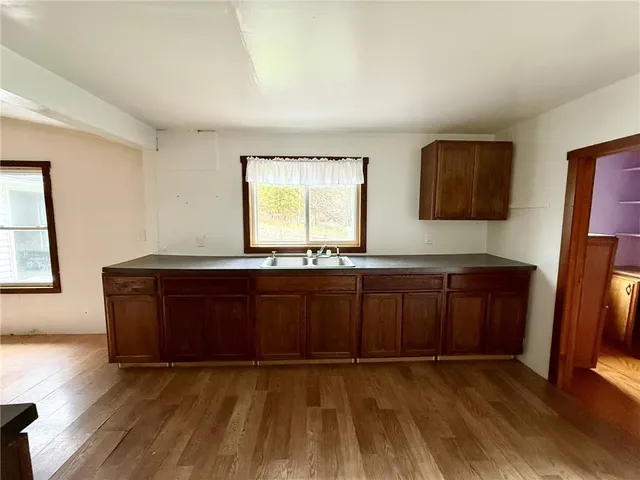a kitchen with granite countertop wooden cabinets and a sink