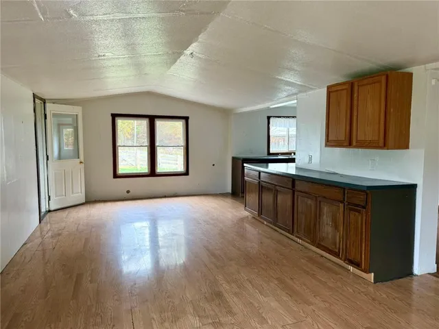 a kitchen with stainless steel appliances granite countertop a stove a sink wooden cabinets and a granite counter top