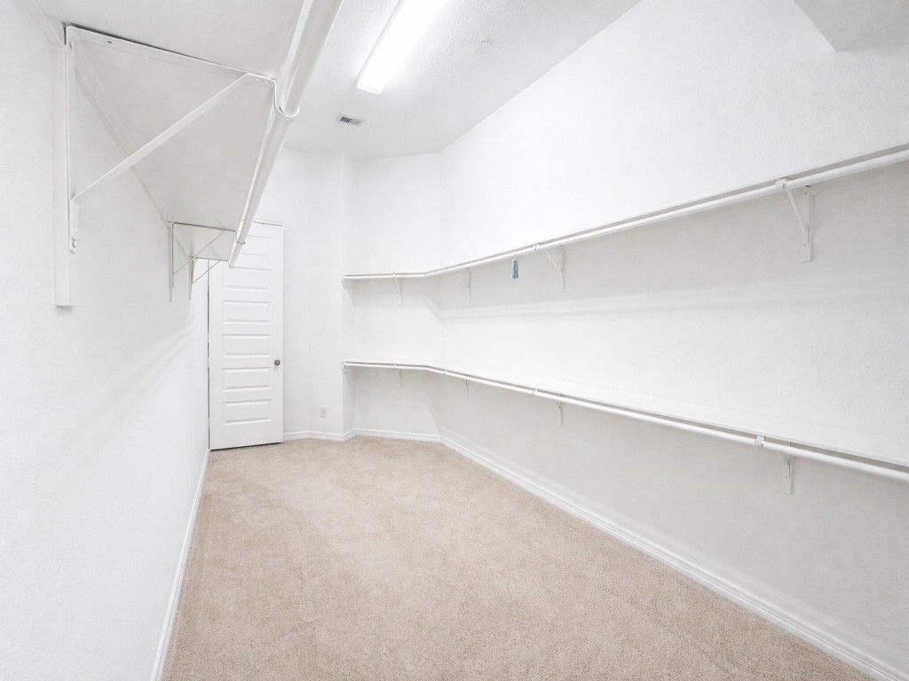 10407 Roseate Skimmer Conroe, TX 77385 - Photo 18 of 30 a view of an empty walk in closet