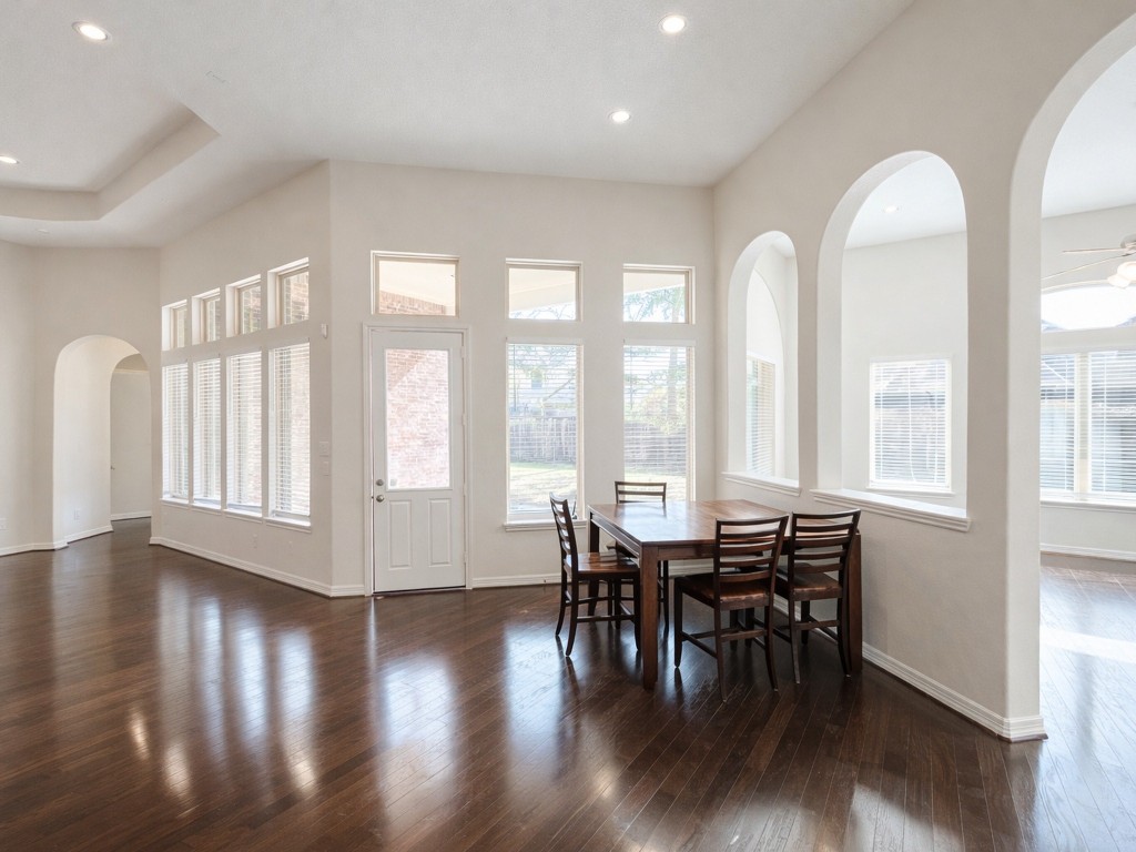 10407 Roseate Skimmer Conroe, TX 77385 - Photo 22 of 30 a view of a dining room with furniture and wooden floor