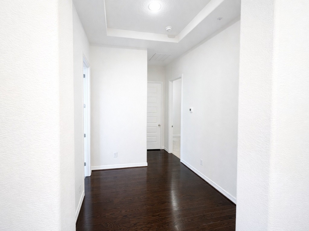 10407 Roseate Skimmer Conroe, TX 77385 - Photo 25 of 30 a view of an empty room with wooden floor