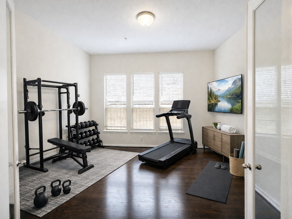10407 Roseate Skimmer Conroe, TX 77385 - Photo 30 of 30 a room with gym equipment and a large window