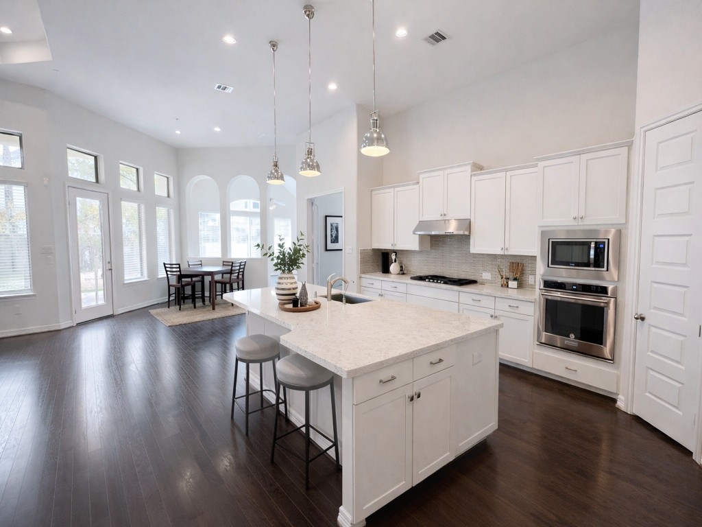 10407 Roseate Skimmer Conroe, TX 77385 - Photo 7 of 30 a kitchen with a stove a sink and a refrigerator