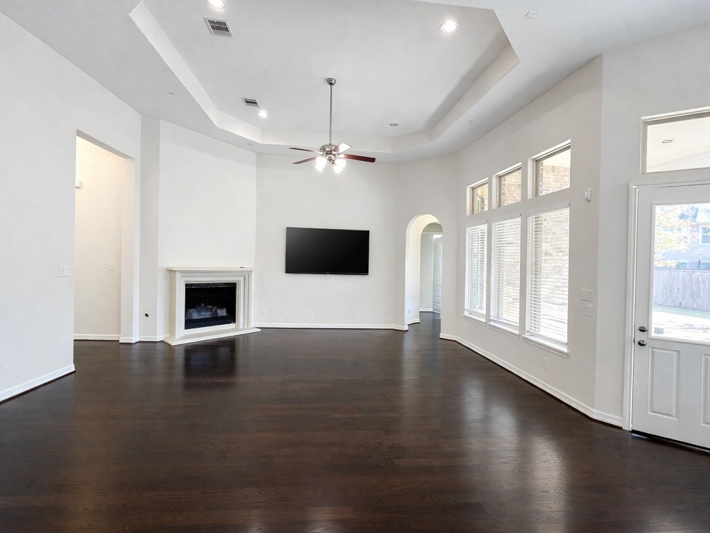 10407 Roseate Skimmer Conroe, TX 77385 - Photo 10 of 30 an empty room with wooden floor and windows