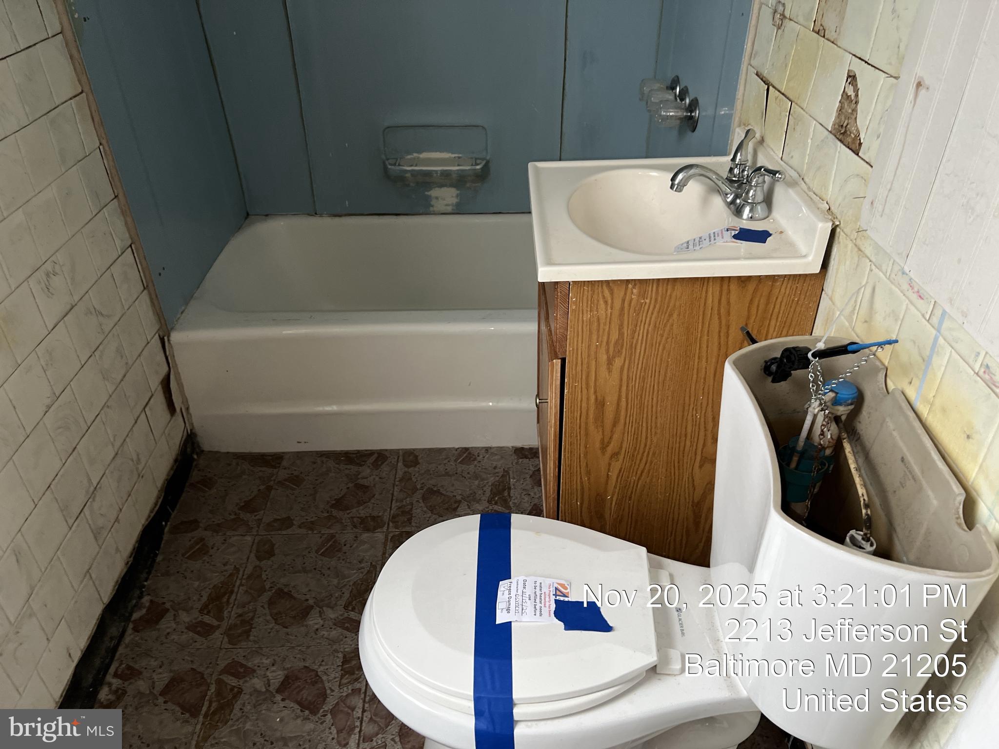 2211 Jefferson Street Baltimore, MD 21205 - Photo 13 of 13 a bathroom with a sink and bathtub
