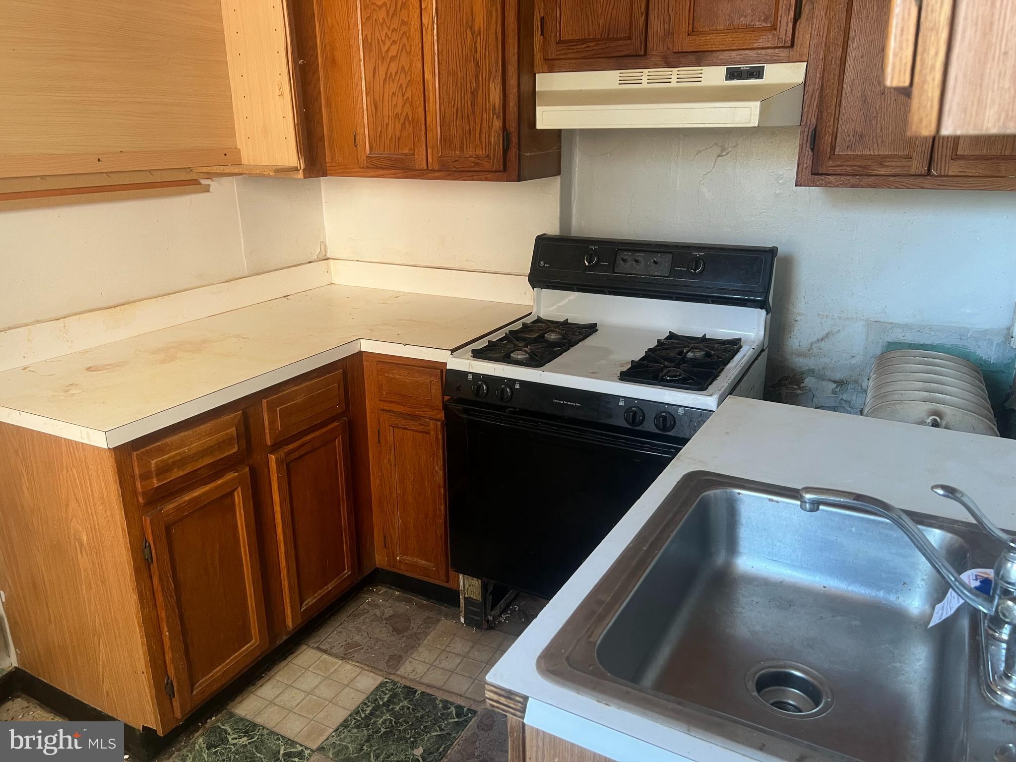 2211 Jefferson Street Baltimore, MD 21205 - Photo 5 of 13 a kitchen with a stove and a sink
