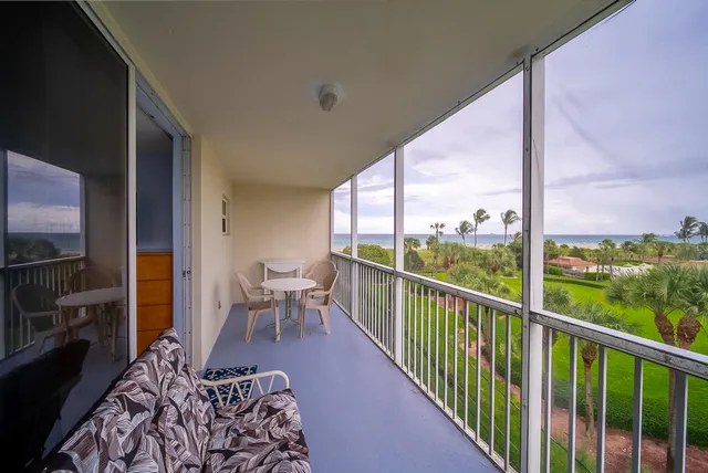 a view of a balcony with chairs