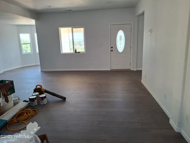 a view of a livingroom with window and hardwood floor