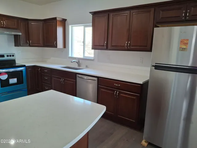 a kitchen with a sink a stove and refrigerator
