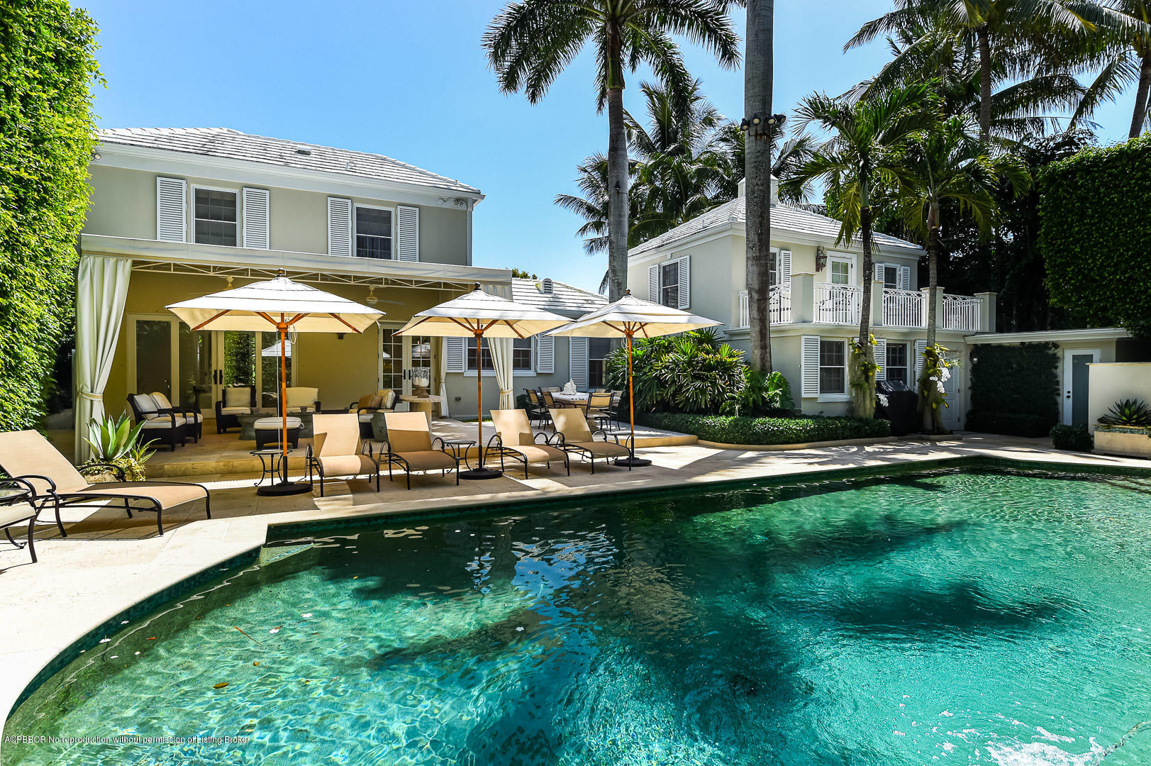 a front view of a house with swimming pool garden and patio