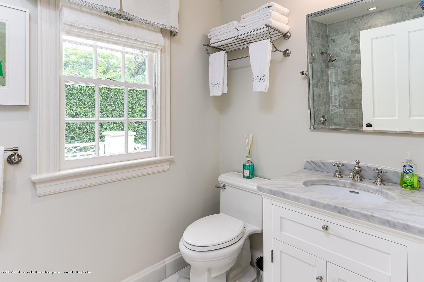 130 Cocoanut Row Palm Beach, FL 33480 - Photo 29 of 31 a bathroom with a granite countertop toilet a sink a mirror and a window