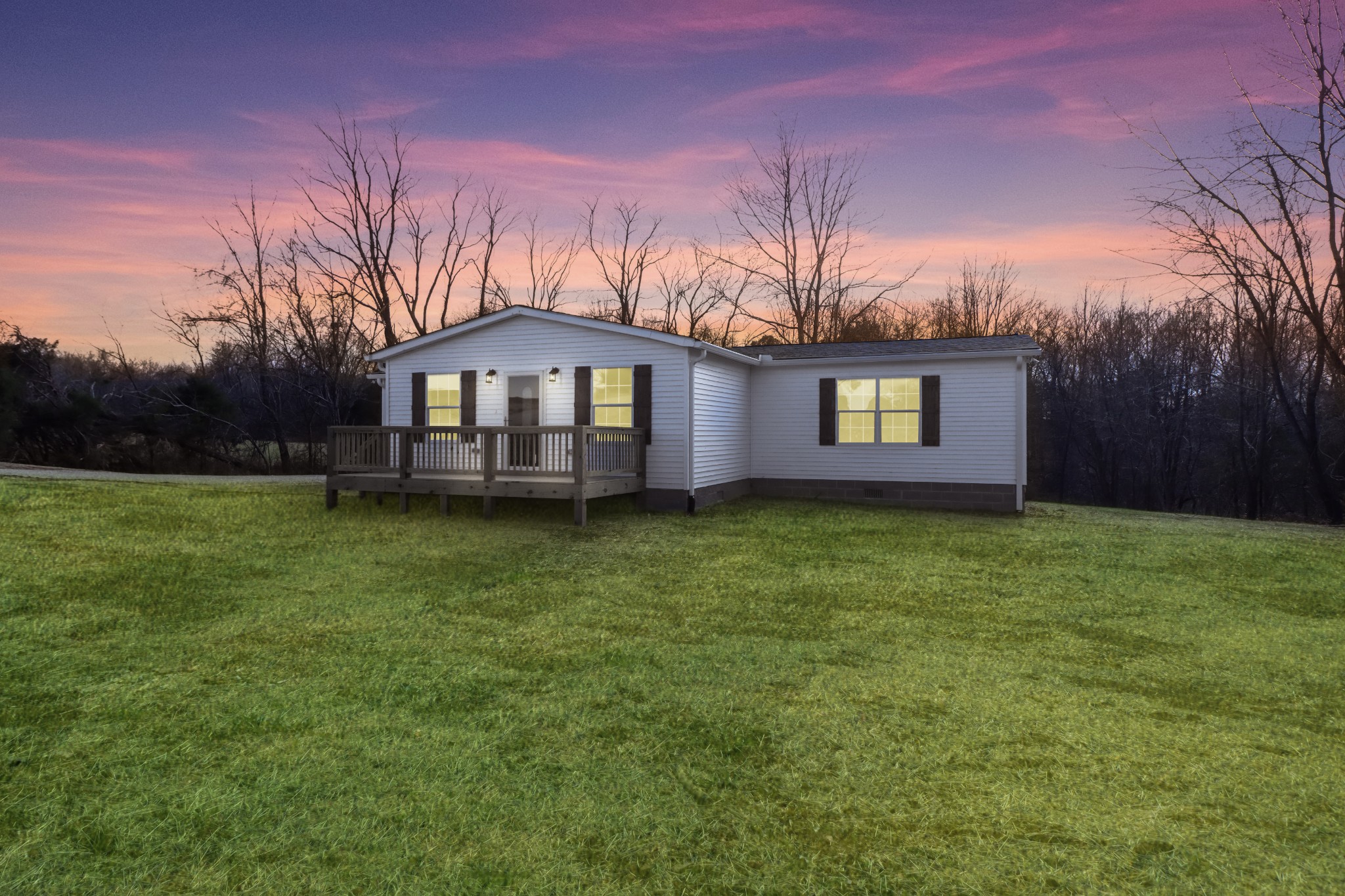 a front view of a house with a garden and yard