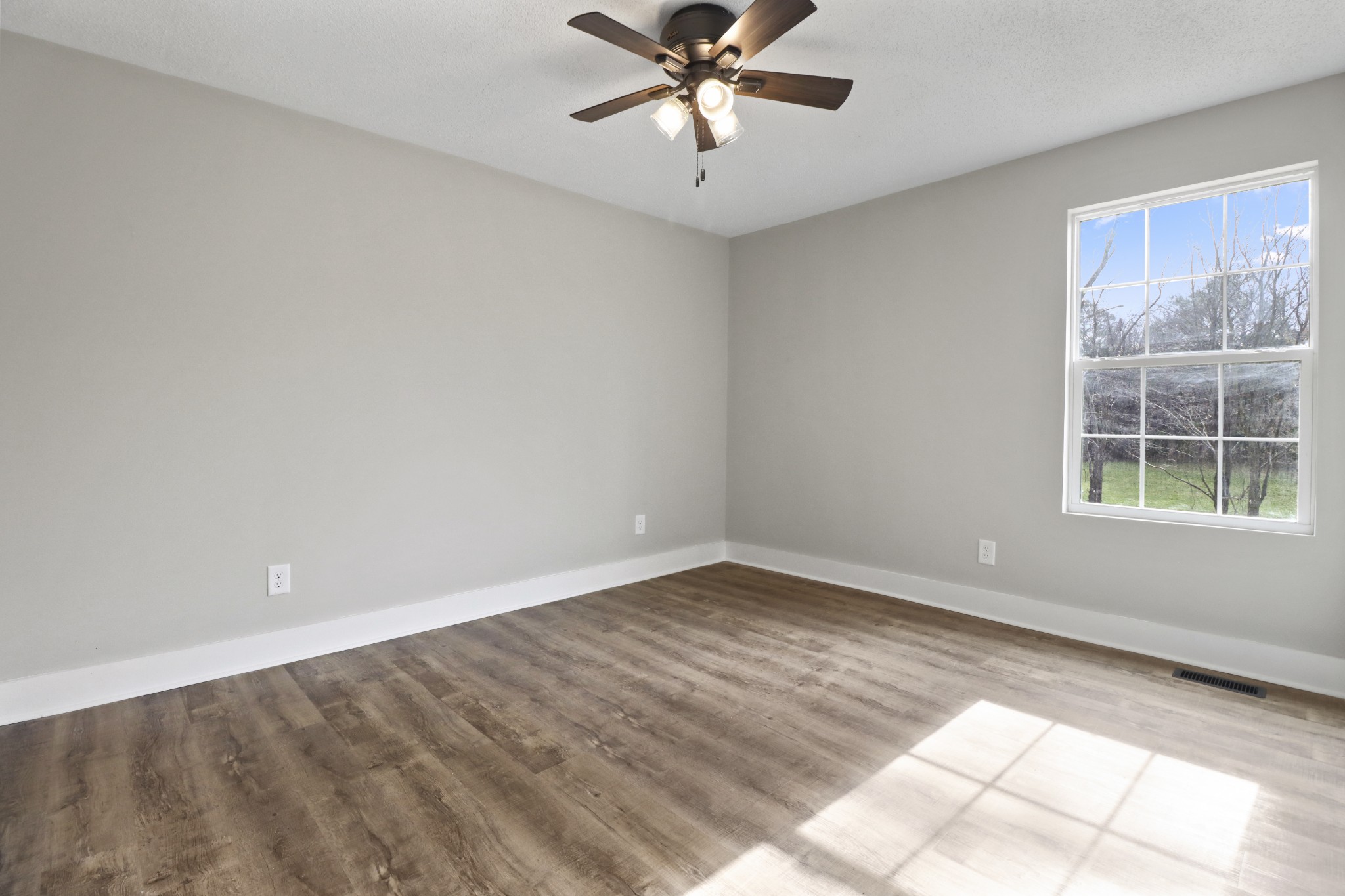 4845 Pulliam-Hardaway Road Springfield, TN 37172 - Photo 14 of 26 a view of a big room with windows and chandelier fan