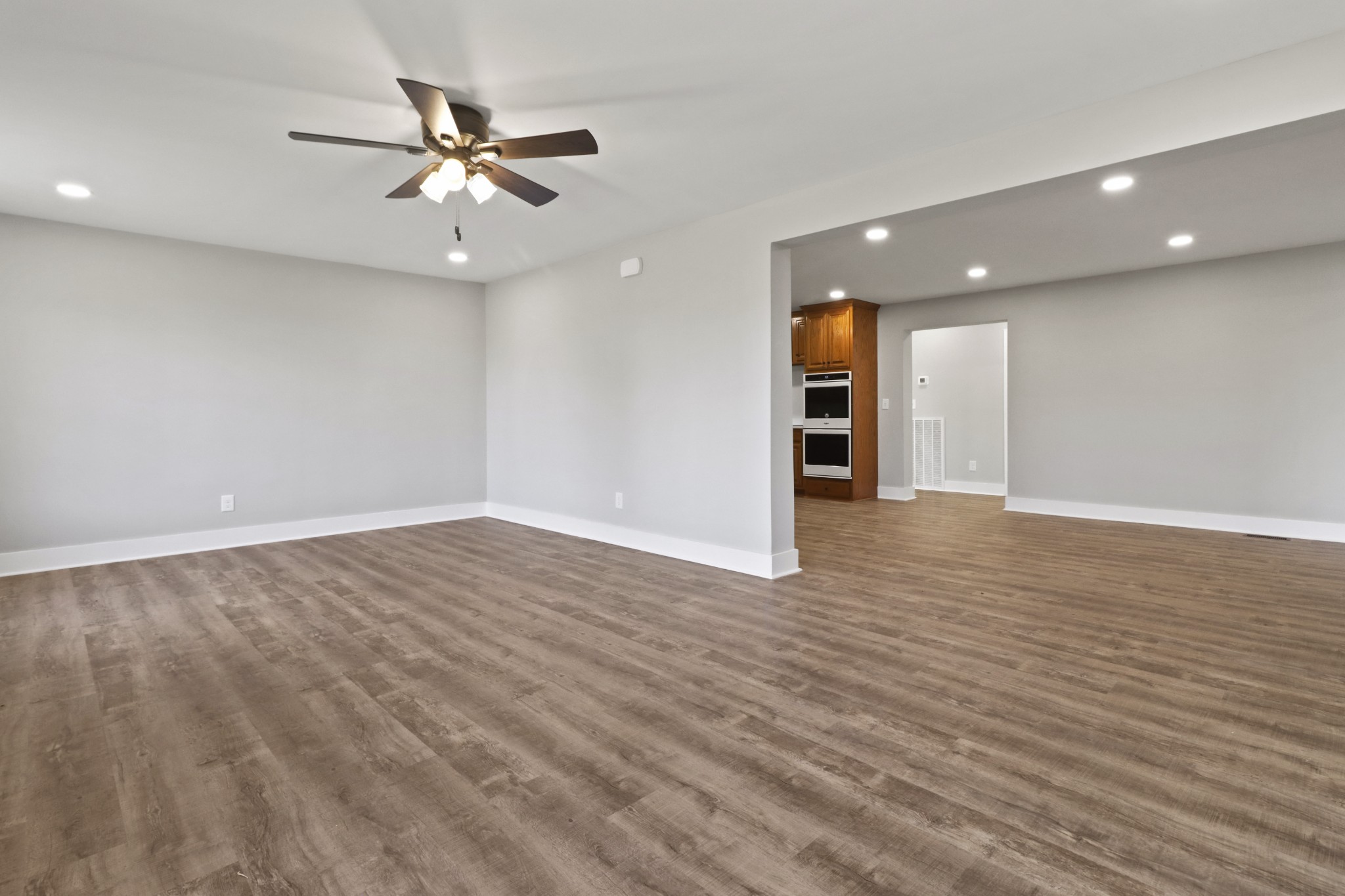 4845 Pulliam-Hardaway Road Springfield, TN 37172 - Photo 7 of 26 an empty room with wooden floor fan and windows