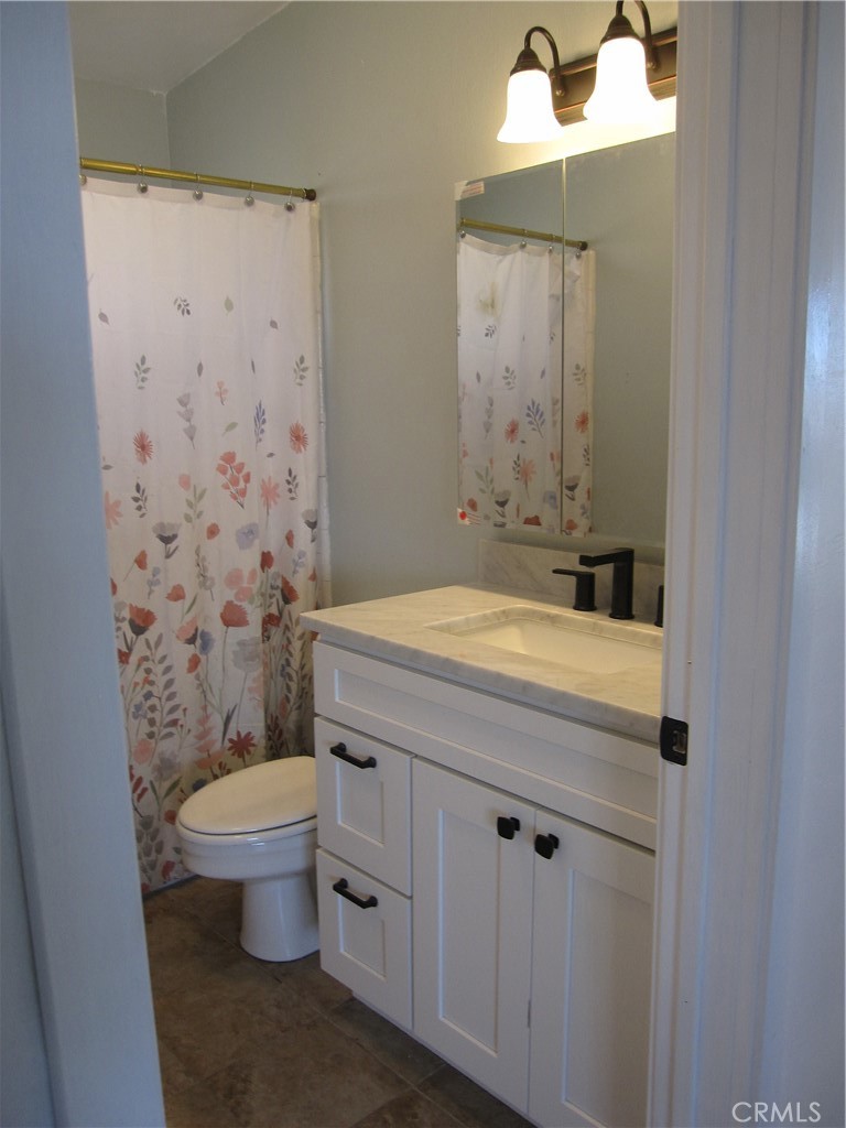 5954 Valley View Street Joshua Tree, CA 92252 - Photo 10 of 10 a bathroom with a sink a toilet and shower