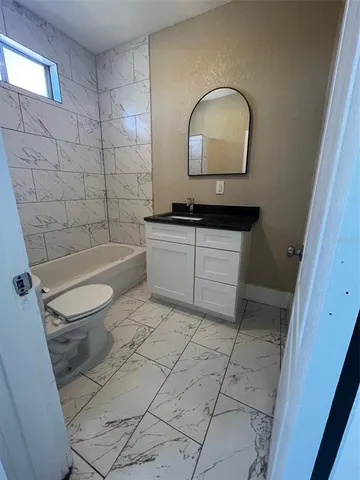 a bathroom with a sink a toilet and a bathtub