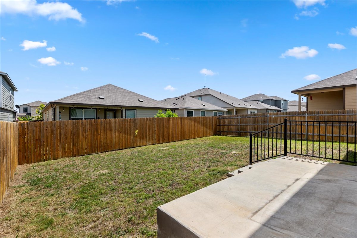 448 Perfect World Loop Jarrell, TX 76537 - Photo 4 of 40 A spacious, enclosed backyard offers a private greenspace for outdoor enjoyment.