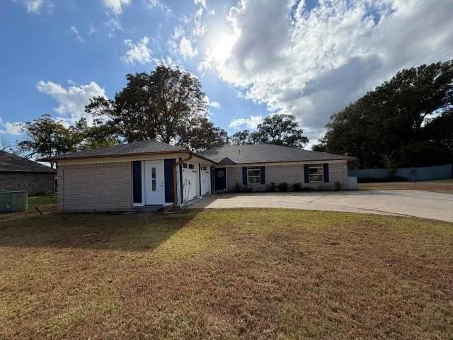 a front view of a house with a yard and a garage